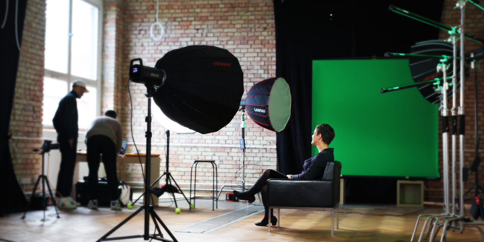 WestWing studio set up for a video interview with softboxes, green screen and brick walls